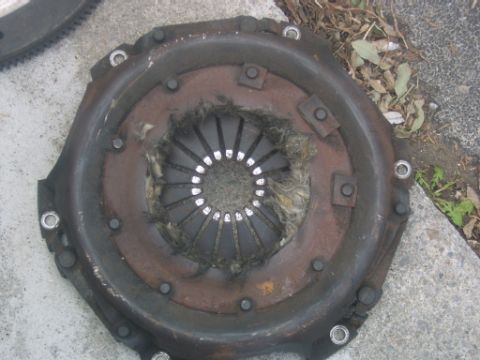 1990 Ford Bronco - A worn clutch assembly is shown, with frayed material visible in the center.