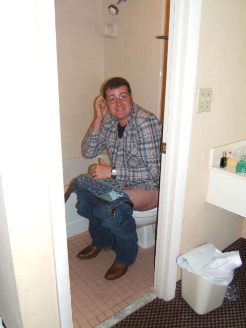 1980 Jeep CJ5 - Man sits on a toilet in a bathroom, giving a thumbs up.