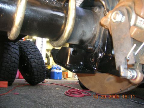 1996 Ford Bronco - A close-up view of a vehicle's suspension system, showing a tire and mechanical parts.
