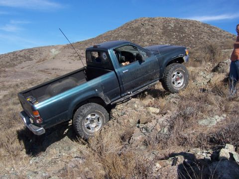 1995 Toyota Hilux - This 1995 Toyota Hilux navigates a challenging rocky terrain on a sunny day.