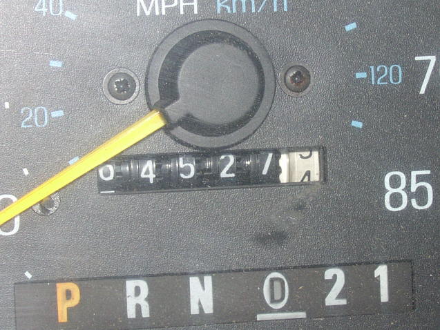 Close-up of a vehicle speedometer and odometer reading mileage
