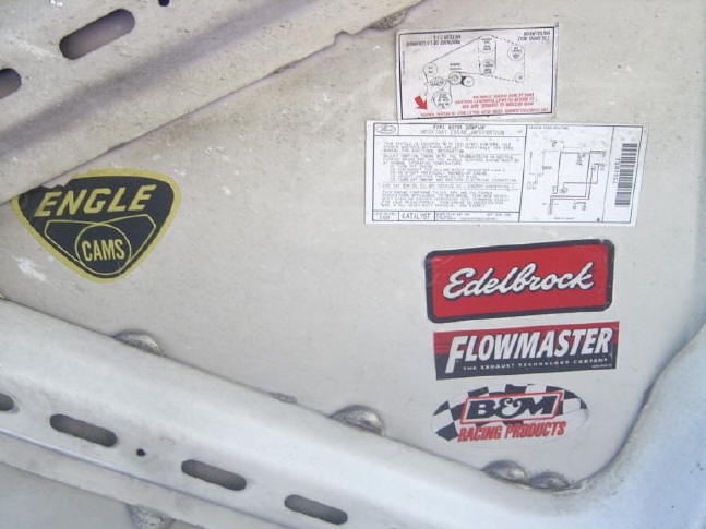 Beige hood underside with Engle Cams, Edelbrock, Flowmaster, and B&M stickers and factory labels
