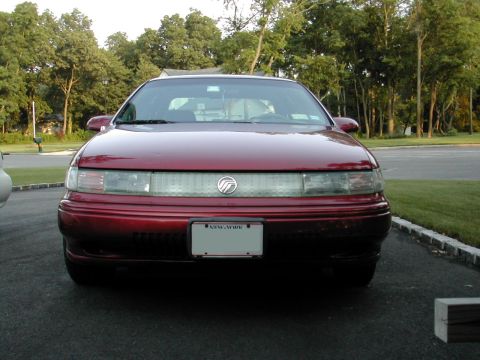 1995 Mercury Sable - Front view of a red 1995 Mercury Sable sedan parked outdoors.