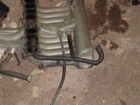 1990 Ford Ranger - This is a close-up view of a Ford intake manifold, likely removed from a vehicle for repair or replacement.