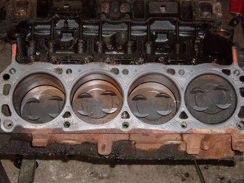1990 Ford Ranger - Close-up view of an engine block's cylinders and pistons, showing wear and oil residue.
