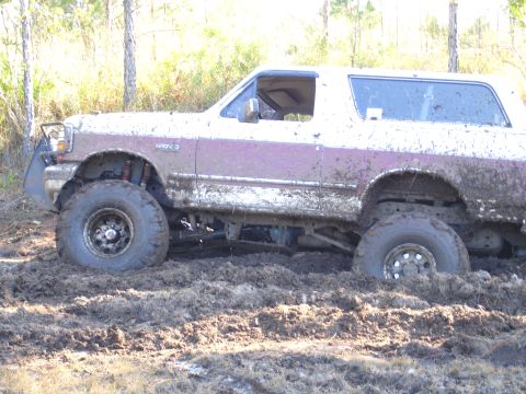 1989 Ford Bronco - This 1989 Ford Bronco is stuck deep in the mud, showing its side profile.