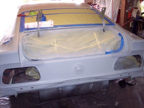 1971 Ford Mustang - The rear of a 1971 Ford Mustang is prepped for painting, with the trunk lid open and the body masked off.