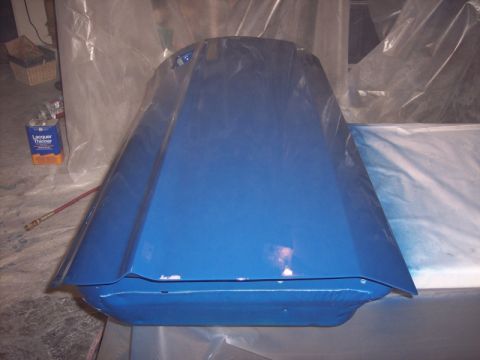 1971 Ford Mustang - A blue car hood is seen from the front, covered in plastic sheeting, with a can of lacquer thinner in the background.