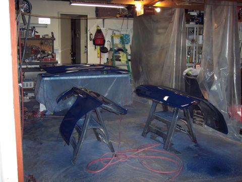 1971 Ford Mustang - Car body panels are staged on sawhorses, likely for a repaint project in a workshop.