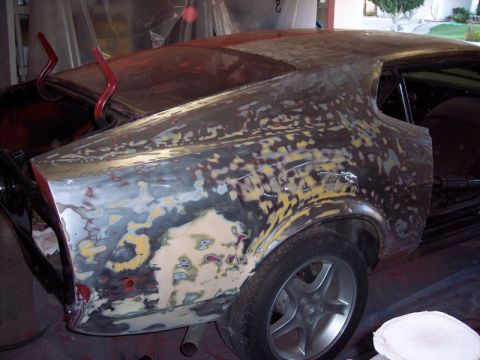 1971 Ford Mustang - Bodywork in progress on a 1971 Ford Mustang, showing primer and filler on the rear quarter panel.