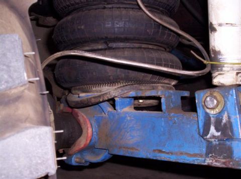 1995 Ford Bronco - Close-up of a vehicle's air suspension system, showing the air bags and associated hardware.