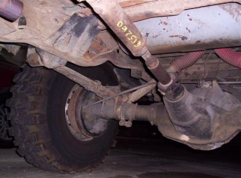 1995 Ford Bronco - The photo shows the undercarriage of a vehicle, focusing on the rear axle and drivetrain components.