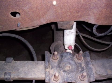 1995 Ford Bronco - Rear suspension component, likely a shock absorber, on a vehicle.