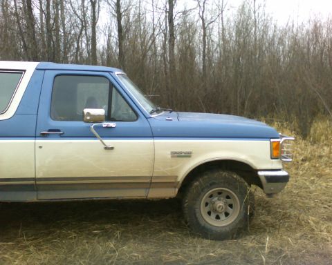 1989 Ford Bronco - This 1989 Ford Bronco is seen from the side in a wooded area.