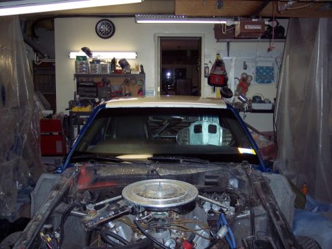 1971 Ford Mustang - This vehicle is in a garage, covered in plastic sheeting, and appears to be undergoing repairs or a repaint project.