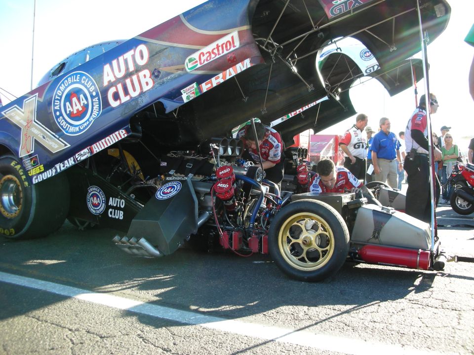 Blue AAA Auto Club nitro Funny Car with body raised in the pits