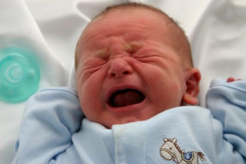 1996 Ford Bronco - A newborn baby cries intensely, with a pacifier nearby.