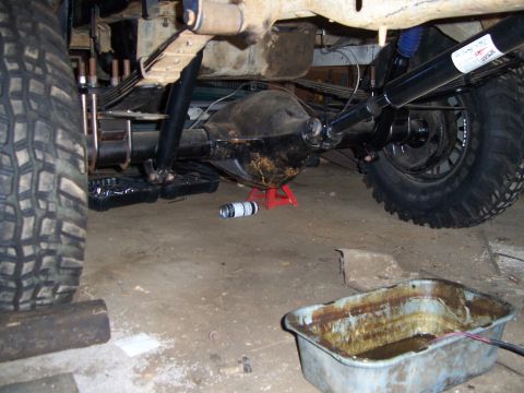1983 Ford Bronco - Vehicle undercarriage repair in progress, showing the rear axle and suspension components.