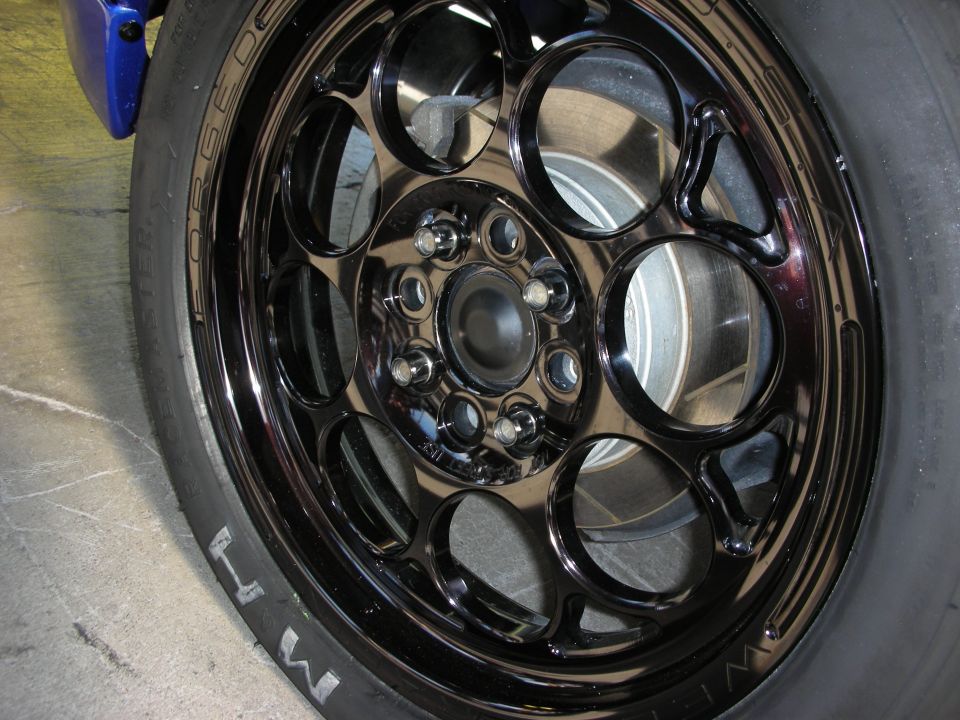 Black multi-hole drag wheel with M/T tire and blue caliper