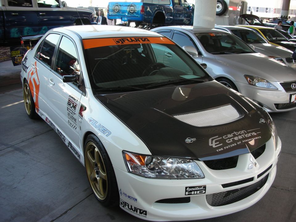 White Mitsubishi Lancer Evolution with carbon hood at indoor show