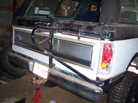 1983 Ford Bronco - This SUV's rear features a spare tire carrier and a license plate reading 315 HZE, suggesting a model from the early 1980s.