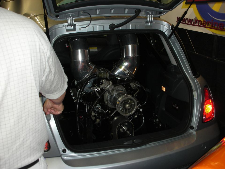 Twin-turbo engine mounted in the hatch cargo area of a silver hatchback