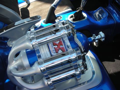 1998 Ford Crown Victoria - polished chrome NX Xpress supercharger and a nitrous bottle are mounted in a bright blue custom build.