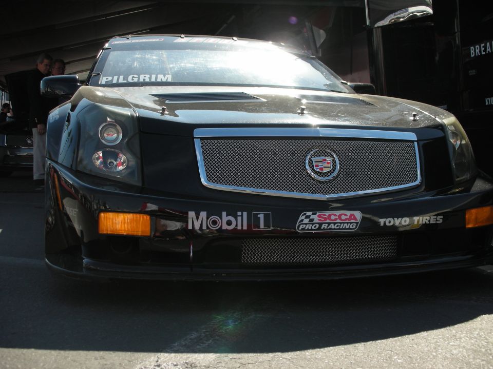 Black Cadillac CTS race car front with mesh grille and SCCA decals