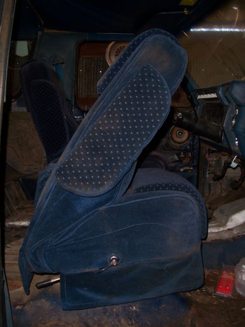 1983 Ford Bronco - Interior view of a vehicle with blue velour seats and dashboard.