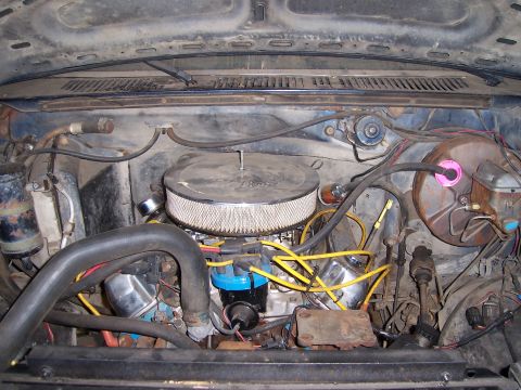 1983 Ford Bronco - The engine bay of a vehicle, showing various components and wiring.
