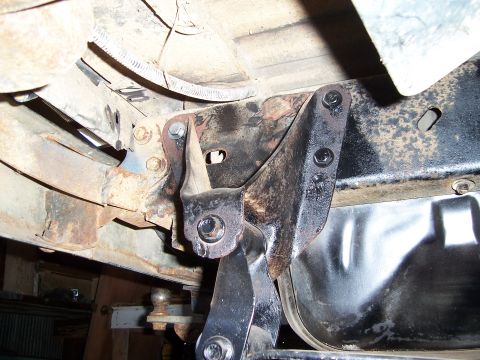 1983 Ford Bronco - Undercarriage view of a vehicle's frame and suspension system, showing various metal components and rust.