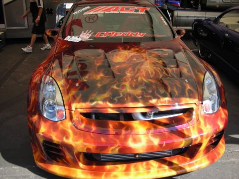 1998 Ford Crown Victoria - Front view of a sport coupe wrapped in airbrushed flame artwork over a front-mount intercooler, with ACT and GReddy windshield banners.