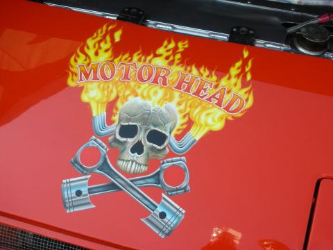 1998 Ford Crown Victoria - red painted panel displays a MOTOR HEAD decal featuring a flaming skull over crossed pistons.