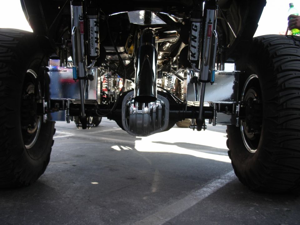 Underbody view of a lifted truck showing rear axle and King coil-over shocks