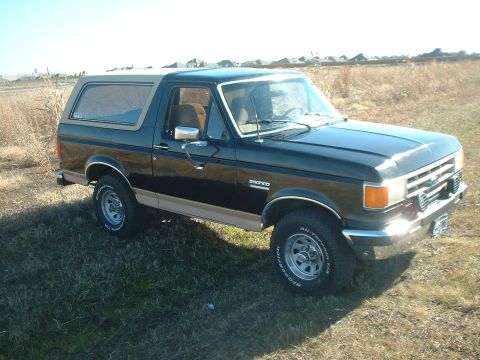 1988 Ford Bronco - This 1988 Ford Bronco is shown from a three-quarter front view in an outdoor setting.