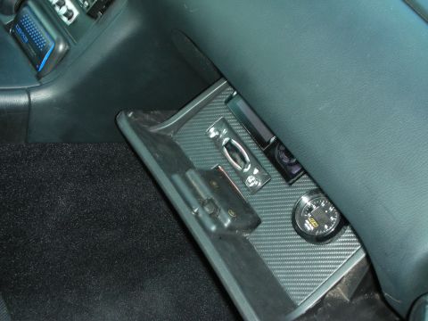 1998 Ford Crown Victoria - vehicle interior trim panel finished in carbon-fiber texture with an inset round gauge.