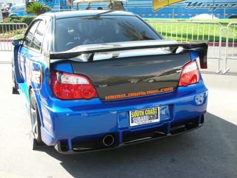 1998 Ford Crown Victoria - Rear of a blue Subaru Impreza with a carbon trunk, wing and South Coast Subaru plate.