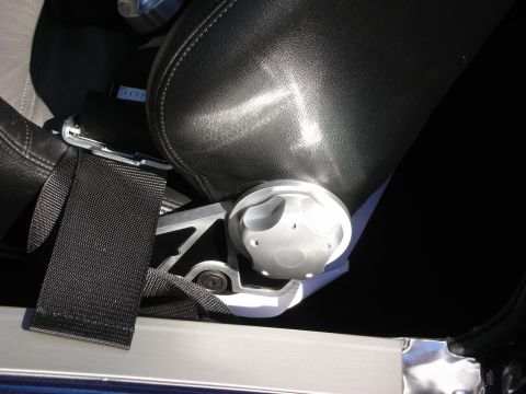 1998 Ford Crown Victoria - black racing harness and billet aluminum bracket mounted at the base of a leather car seat.