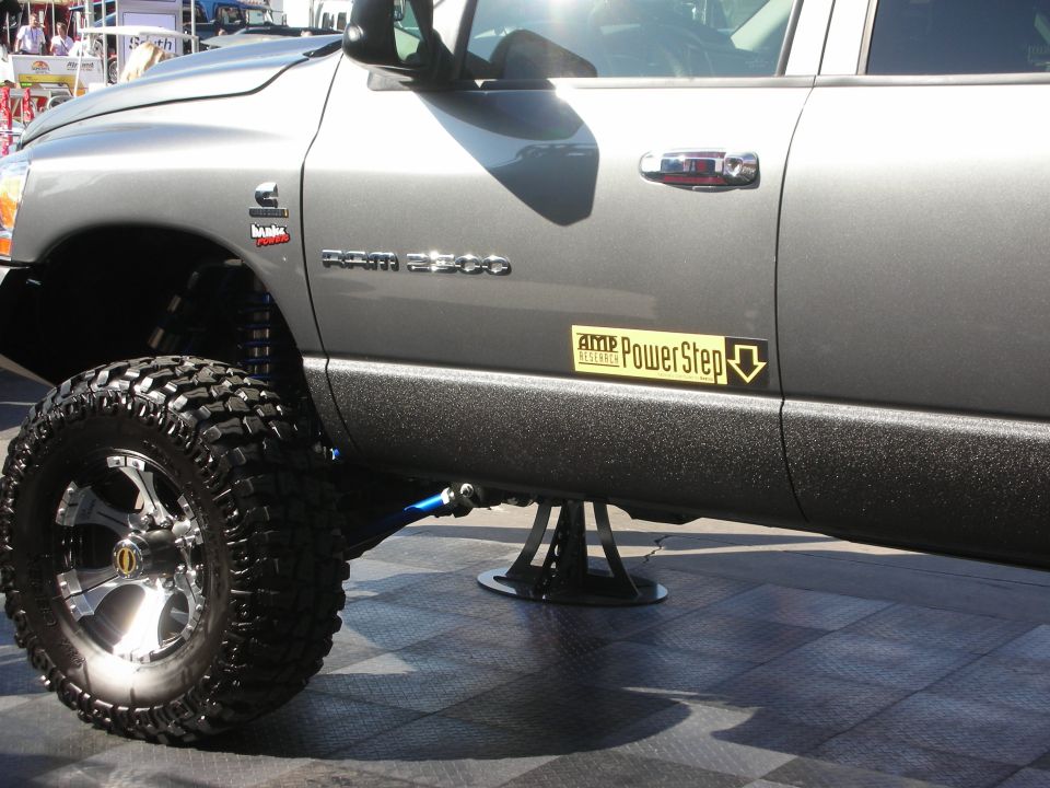 Side of a lifted gray Dodge Ram 2500 Cummins diesel truck on a stand