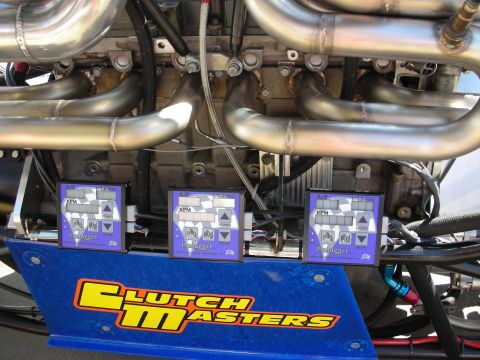 1998 Ford Crown Victoria - Three blue digital RPM display units mounted above stainless headers on a blue Clutch Masters panel of a race car.