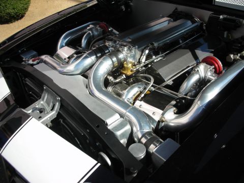 1998 Ford Crown Victoria - meticulously detailed engine bay shows a polished inline engine fed by twin chrome intercooler piping and red couplers.