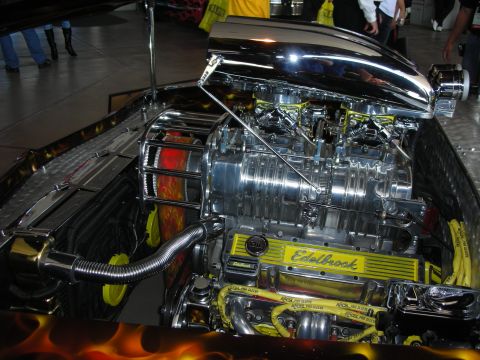1998 Ford Crown Victoria - polished supercharger and scoop top an engine with Edelbrock valve covers in a flame-painted engine bay.