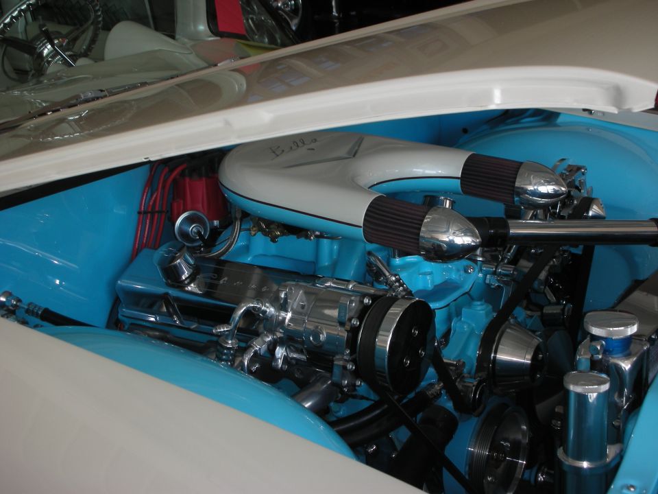 Custom turquoise engine bay with chrome air cleaners and polished accessories