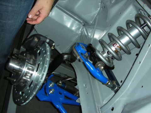 1998 Ford Crown Victoria - Close-up of a tubular front suspension showing a drilled brake rotor, silver coilover shock and blue lower control arm.