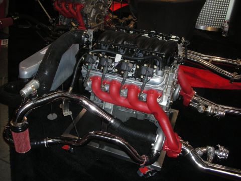 1998 Ford Crown Victoria - Display V8 engine fitted with red ceramic-coated exhaust headers, polished piping and a red cone air filter.