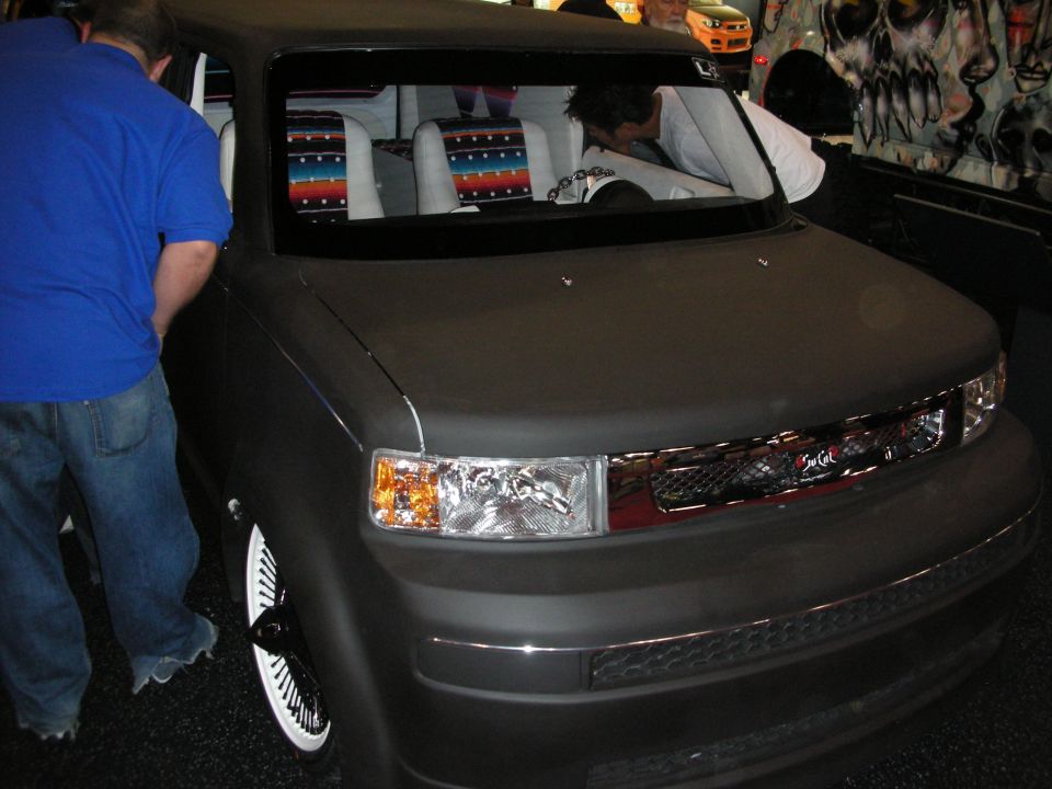 Slammed gray Scion xB box car with custom Serape interior at a show