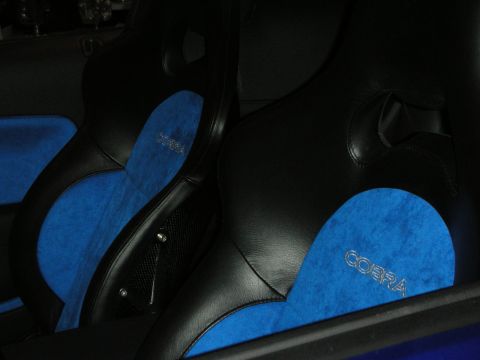 1998 Ford Crown Victoria - pair of black leather sport seats with bright blue suede center panels embroidered with the word Cobra.