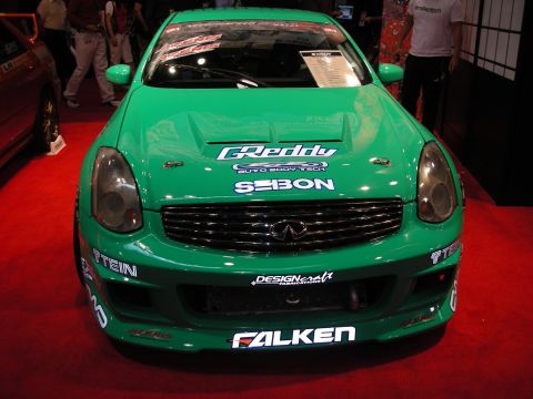 1998 Ford Crown Victoria - Front view of a bright green Infiniti coupe show car covered in Greddy, Seibon, Tein and Falken sponsor decals.