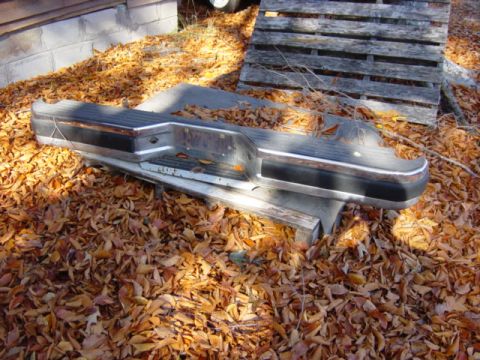 1991 Ford Bronco - This rear bumper is for sale and is shown outdoors on a bed of autumn leaves.