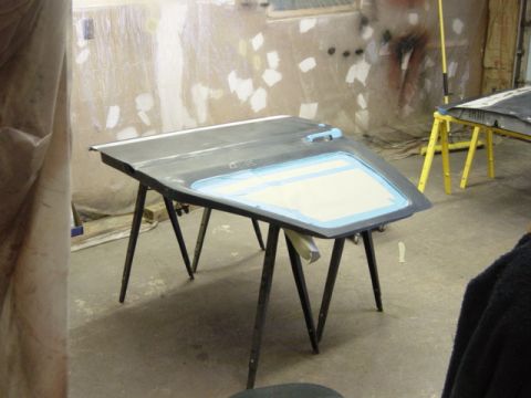 1991 Ford Bronco - Car door undergoing preparation in a workshop setting.